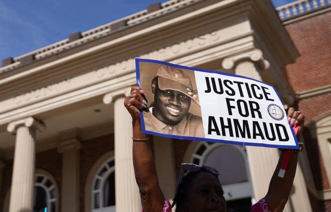 On January 18, 2021, a protester holds up a placard demanding justice for Ahmaud Arbery outside the court in Glynn County, Georgia.