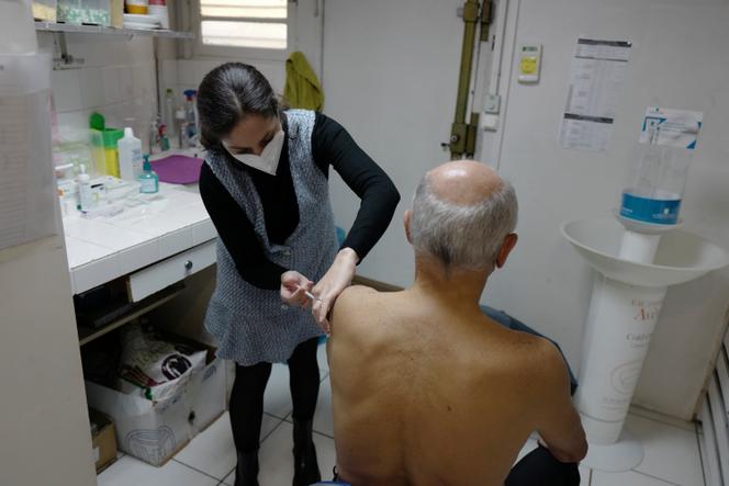 A 71-year-old man receives a booster dose of Pfizer's Covid-19 vaccine in Paris on October 25, 2021.