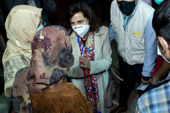 Spanish Defense Minister Margarita Robles (center) greets Afghan refugees upon their arrival at the Torrejon de Ardoz military base, near Madrid, on October 12, 2021.