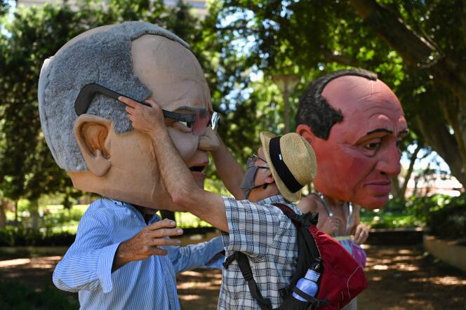People carry caricatures of Australian Prime Minister Scott Morrison (left) and Deputy Prime Minister Barnaby Joyce on a global day of action on climate change in Sydney on November 6, 2021.