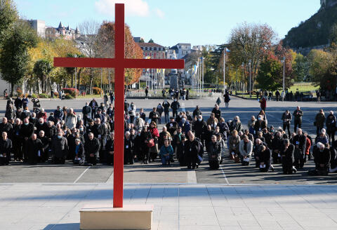 Bishops gesture on the forecourt of the Notre-Dame-du-Rosaire basilica in the sanctuary of Lourdes, southwestern France, Saturday, Nov. 6, 2021 during a ceremony, part of The Bishops' Conference, the first after a commission revealed the level of sex abuse within the Roman Catholic church in France. The ceremony was held in homage of the victims. (AP Photo/Bob Edme)
