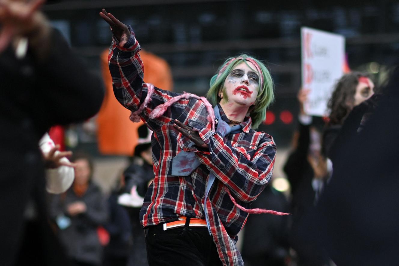 Members of Extinction Rebellion perform a zombie dance in George Square, Glasgow on November 7, 2021.