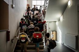 Pupils climb the stairs at an elementary school on September 2, 2021 in Lyon, on the first day of the French school year. (Photo by JEFF PACHOUD / AFP)