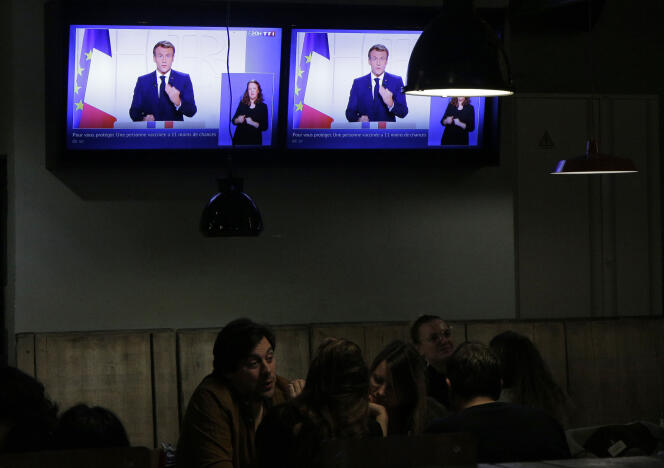 Emmanuel Macron's televised address is broadcast in a bar in Lille on November 9, 2021.