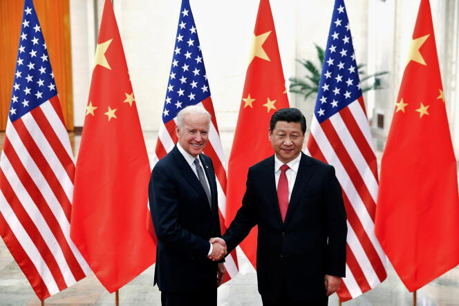 Chinese President Xi Jinping shakes hands with Joe Biden inside the Great Hall of the People in Beijing on December 4, 2013.