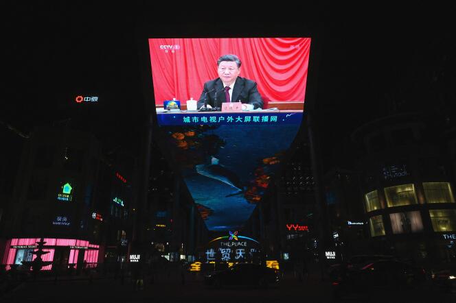 Chinese President Xi Jinping is seen on a big screen during a newscast at a shopping mall in Beijing on November 11, 2021.