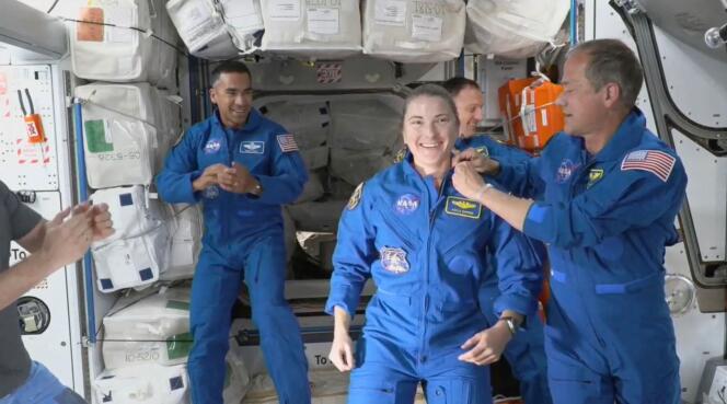 L’astronaute Tom Marshburn épingle l’insigne officiel de la NASA sur la tenue de Kayla Barron, après l’arrivée de l’équipage Crew-3 dans l’ISS, le 11 novembre 2021.