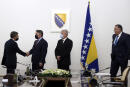 In this photo provided by the Bosnian Presidential Press Service, U.S. State Department Counselor Derek Chollet, left, shakes hands with Croat member of the tripartite Presidency of Bosnia Zeljko Komsic in Sarajevo, Bosnia, Tuesday, Nov. 16, 2021. Muslim member of the tripartite Presidency of Bosnia Sefik Dzaferovic is second right and Bosnian Serb member of the tripartite Presidency of Bosnia Milorad Dodik is right right. The United States is paying very close attention to the situation in Bosnia and has tools it can utilize against the divisive nationalist leaders in the war-scared, multiethnic Balkan country who would try to "tear it apart," a senior U.S. official said. (Bosnian Presidential Press Service via AP)