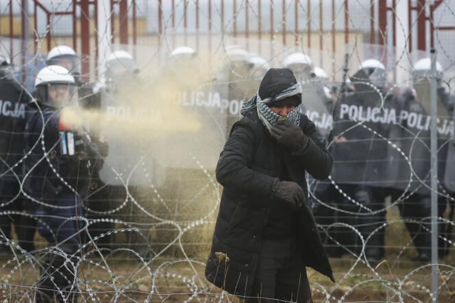 Un militaire polonais pulvérise des gaz lacrymogènes près de Grodno, en Biélorussie, le 16 novembre 2021.