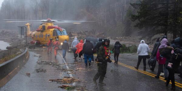 Crew members of the 442nd Squadron of the Royal Canadian Air Force evacuate motorists stranded by mudslides in Agassiz, British Columbia on November 15, 2021.