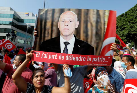 FILE PHOTO: Supporters of Tunisian President Kais Saied rally in support of his seizure of power and suspension of parliament, in Tunis, Tunisia, October 3, 2021. REUTERS/Zoubeir Souissi/File Photo