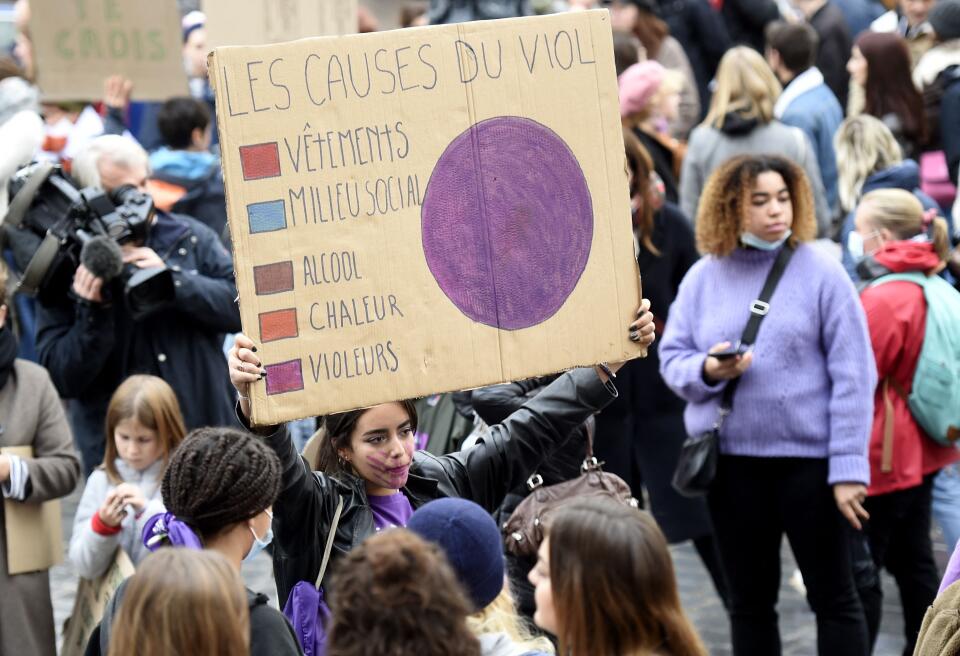 A protester holds a placard during a demonstration organised by "NousToutes" (All of Us), a French feminist collective, against sexist and sexual violence, in Lille, northern France, on November 21, 2021. (Photo by FRANCOIS LO PRESTI / AFP)