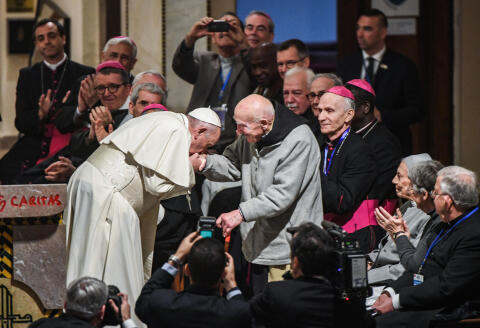 (FILES) In this file photo taken on March 31, 2019 Pope Francis (C-L) bends to kiss the hand of French Catholic monk Brother Jean-Pierre Schumacher (C-R), the last survivor of the hostage taking of the seven monks of Tibhirine during the Algerian civil war in 1996, at St Peter's Roman Catholic Cathedral in the Moroccan capital Rabat on March 31, 2019. - Schumacher, the last survivor of the seven monks of Tibhirine, died on November 21, 2021. (Photo by FADEL SENNA / AFP)