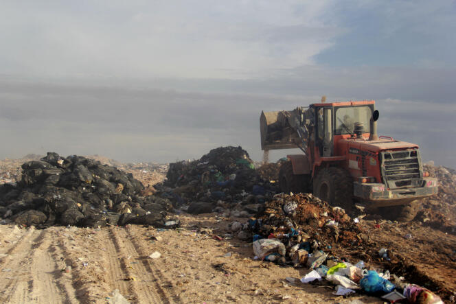 A bulldozer buries rubbish after the reopening of a landfill near the Tunisian town of Agareb, in the coastal region of Sfax, on November 9, 2021.