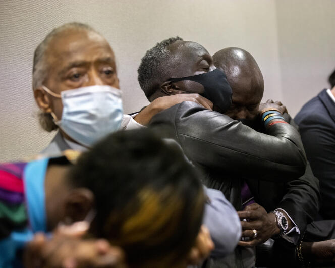 Ahmaud Arbery's father, Marcus Arbery, hugs his lawyer as the three men charged with the murder of his son were found guilty on November 24, 2021.