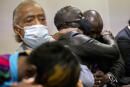 Ahmaud Arbery's father Marcus Arbery, center, his hugged by his attorney Benjamin Crump after the jury convicted Travis McMichael in the Glynn County Courthouse, Wednesday, Nov. 24, 2021, in Brunswick, Ga. Greg McMichael and his son, Travis McMichael, and a neighbor, William "Roddie" Bryan were convicted of murder Wednesday in the fatal shooting that became part of a larger national reckoning on racial injustice.(AP Photo/Stephen B. Morton, Pool)