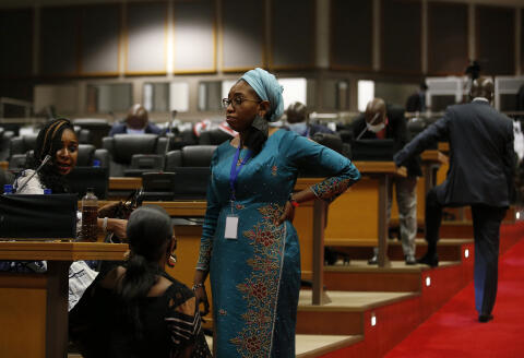 Pan African Parliament members stand inside the house following its postponement in Midrand, Johannesburg on June 1, 2021. - The house was adjourned following chaotic and violent scenes that played out during the leadership rotation elections. (Photo by Phill Magakoe / AFP)
