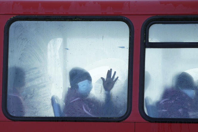 Migrants wait on a bus, after being brought to Dover, Kent (UK) on November 25, 2021.