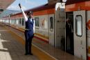FILE PHOTO: A Kenya Railways attendant gestures next to a train along the Standard Gauge Railway (SGR) line constructed by the China Road and Bridge Corporation (CRBC) and financed by Chinese government in Mai Mahiu, Kenya October 16, 2019. REUTERS/Thomas Mukoya/File Photo