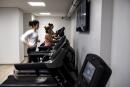 People run on treadmills at a fitness centre in Paris on February 3, 2020. (Photo by Christophe ARCHAMBAULT / AFP)