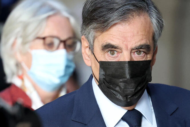 France's former prime minister Francois Fillon and his wife Penelope Fillon arrive at a Paris courthouse for their trial on November 22, 2021.