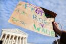 A person holds a placard during a protest outside the Supreme Court building, on the day of the arguments in the Mississippi abortion rights case Dobbs v. Jackson Women's Health, in Washington, U.S., December 1, 2021. REUTERS/Evelyn Hockstein
