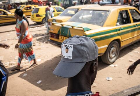 A young man wears a hat in support of current President of Gambia, Adama Barrow and his newly formed political party, National People’s Party(NPP) at a busy intersection in the popular neighbourhood of Serrekunda in Banjul on December 2, 2021, two days before Presidential elections on December 4, 2021. (Photo by JOHN WESSELS / AFP)