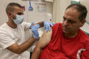 A health worker administers a dose of the Pfizer-BioNtech COVID-19 coronavirus vaccine on a man at the Clalit Health Services in the Palestinian neighbourhood of Beit Hanina, in the Israeli-annexed east Jerusalem on August 29, 2021 - Israel widened access to a third coronavirus vaccine jab to anyone aged 12 and up, with Prime Minister Naftali Bennett insisting it was an effective way to contain an infection surge. Moves by several nations to offer third jabs have faced criticism including from the World Health Organization, which insists poorer countries should gain wider access to vaccines before wealthy ones offer booster shots. (Photo by AHMAD GHARABLI / AFP)