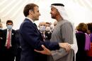 French President Emmanuel Macron (L) is greeted by Abu Dhabi's Crown Prince Mohammed bin Zayed al-Nahyan during his tour of the French pavillion at the Dubai Expo on the first day of his Gulf tour on December 3, 2021. The UAE signed among other deals today a record, 14-billion-euro contract for 80 French-made Rafale warplanes and committed billions of euros in other agremments as Macron kicked off a Gulf tour that will also take him to Qatar and Saudi Arabia. (Photo by Thomas SAMSON / AFP)