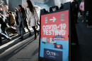 NEW YORK, NEW YORK - DECEMBER 05: People walk by groups of people lined-up to get tested for Covid-19 in Times Square on December 05, 2021 in New York City. With the newly discovered omicron strain of Covid, health officials are urging people to get a vaccination or a booster and get tested for Covid. Spencer Platt/Getty Images/AFP (Photo by SPENCER PLATT / GETTY IMAGES NORTH AMERICA / Getty Images via AFP)