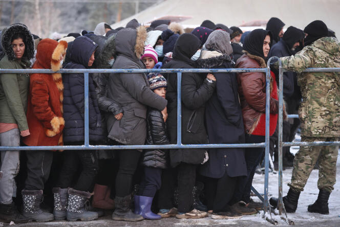 Migrants wait for the distribution of food aid at the Belarus-Poland border on December 1, 2021.