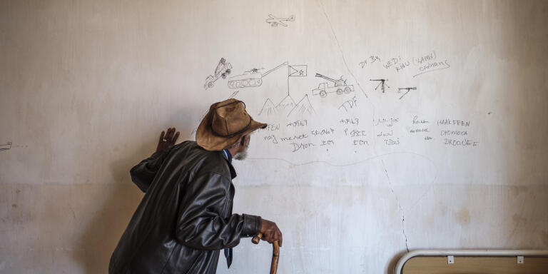 Woldemariam Deginetu, manager of a clinic, looks a a graffiti written in the wall of a looted facility in a clinic in the village of Mezezo, Ethiopia, on December 08, 2021.
The clinic was looted by Tigrayan forces while they occupied the village. The village of Mezazo was part the front line of the conflict between the federal and the Tigrayan forces for a week.