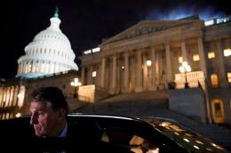 FILE PHOTO: U.S. Senator Joe Manchin (D-WV) gets into a car as he leaves the U.S. Capitol in Washington, U.S., December 15, 2021. REUTERS/Elizabeth Frantz/File Photo