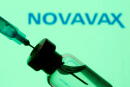 FILE PHOTO: A vial and sryinge are seen in front of a displayed Novavax logo in this illustration taken January 11, 2021. REUTERS/Dado Ruvic/Illustration/File Photo
