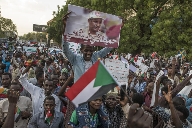 Protesters hold up the portrait of Mohammed Hamdan Daglo, also known as Hemetti, in Khartoum on May 31, 2019.
