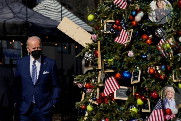 US President Joe Biden admires a Christmas tree decorated in honor of American teachers, in Washington on Friday, December 24, 2021.