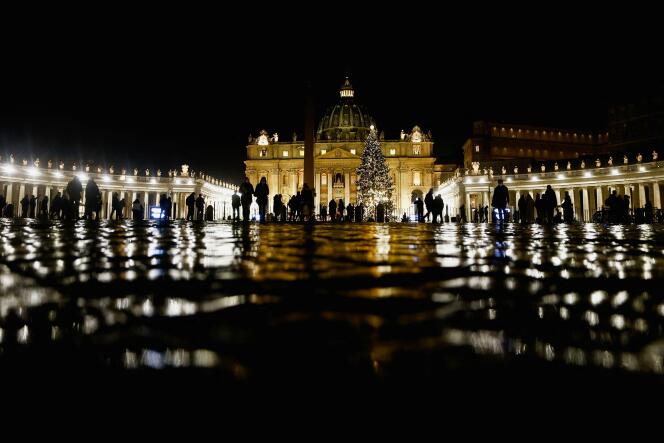 People gather in St. Peter's Square ahead of Pope Francis' Christmas Eve Mass at the Vatican on December 24, 2021.