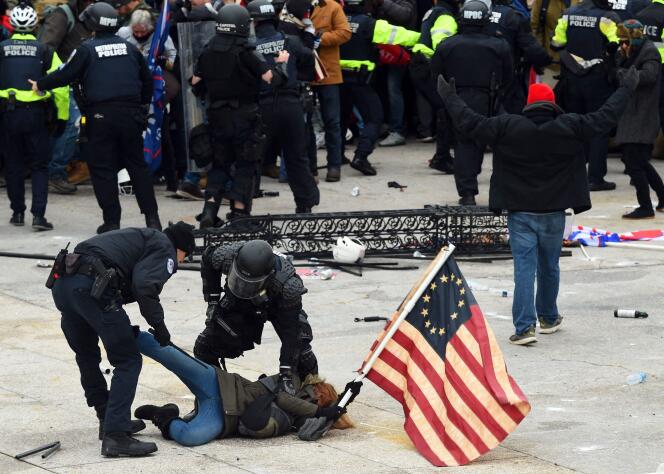 Members of the police overpower a supporter of Donald Trump participating in the assault on the Capitol, January 6, 2021.