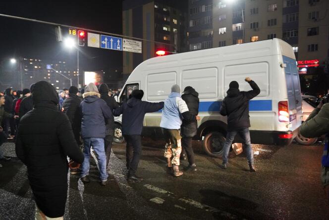 Protesters try to block a police vehicle on January 4, 2022 in Almaty, Kazakhstan.