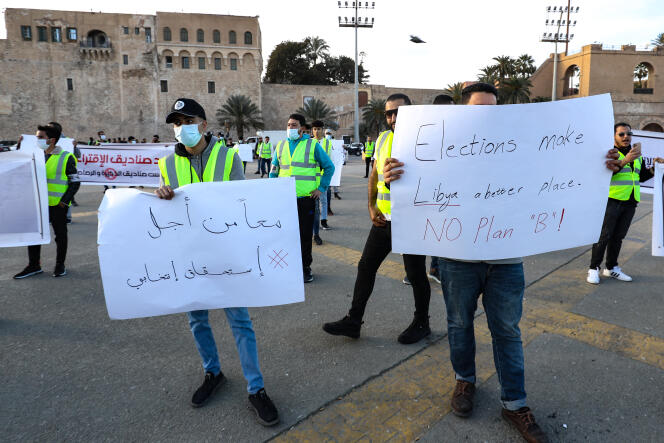 Young Libyan activists protest against the postponement of the presidential election in Martyrs Square in the capital Tripoli on December 25, 2021.