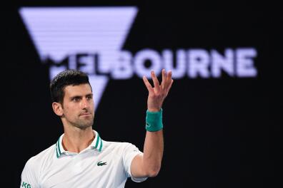 (FILES) In this file photo taken on February 21, 2021, Serbia's Novak Djokovic reacts after a point against Russia's Daniil Medvedev during their men's singles final match on day fourteen of the Australian Open tennis tournament in Melbourne. Detained tennis world number one Novak Djokovic fought against deportation from Australia on January 6, 2022, after the government revoked his visa for failing to meet pandemic vaccine entry requirements. - -- IMAGE RESTRICTED TO EDITORIAL USE - STRICTLY NO COMMERCIAL USE -- (Photo by William WEST / AFP) / -- IMAGE RESTRICTED TO EDITORIAL USE - STRICTLY NO COMMERCIAL USE --