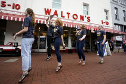 BENTONVILLE, AR - MAY 31: Walmart associates dance in front of Sam Walton's original 5 &amp; 10 store, now a museum, during the annual shareholders meeting event on May 31, 2018 in Bentonville, Arkansas. The shareholders week brings thousands of shareholders and associates from around the world to meet at the company's global headquarters. Rick T. Wilking/Getty Images/AFP (Photo by Rick T. Wilking / GETTY IMAGES NORTH AMERICA / Getty Images via AFP)