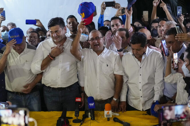 Opposition candidate Sergio Garrido (center) celebrates his victory in the election of governor of the state of Barinas, Venezuela, Sunday January 9, 2022.