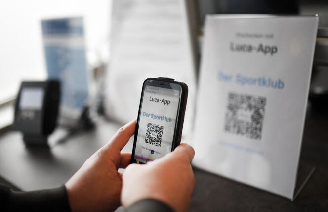 A visitor to a fitness center uses the Luca app for registration, in Havixbeck, near Coesfeld, western Germany, May 4, 2021.