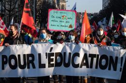 Protestors hold a banner reading "Fro education" during a demonstration called by teachers' unions to denounce "an indescribable mess" because of the new government's measures agaisnt Covid-19, in Strasbourg, north-eastern France, on January 13, 2022. According to the forecasts of the Snuipp-FSU, the leading primary school union, 75% of primary school teachers may not go through the school gates on January 13, 2022, and half of them should therefore be closed. (Photo by PATRICK HERTZOG / AFP)