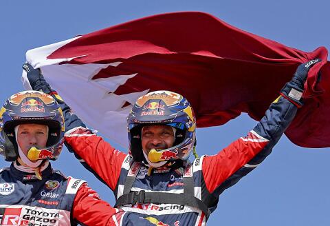 Toyota's driver Nasser Al-Attiyah of Qatar (R) and his co-driver Mathieu Baumel of France celebrate their victory after winning the Dakar Rally 2022, at the end of the last stage between Bisha and Jeddah in Saudi Arabia, on January 14, 2022. (Photo by FRANCK FIFE / AFP)