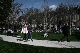 People walk in a park, in Bordeaux, southwestern France, on March 4, 2021. (Photo by Philippe LOPEZ / AFP)