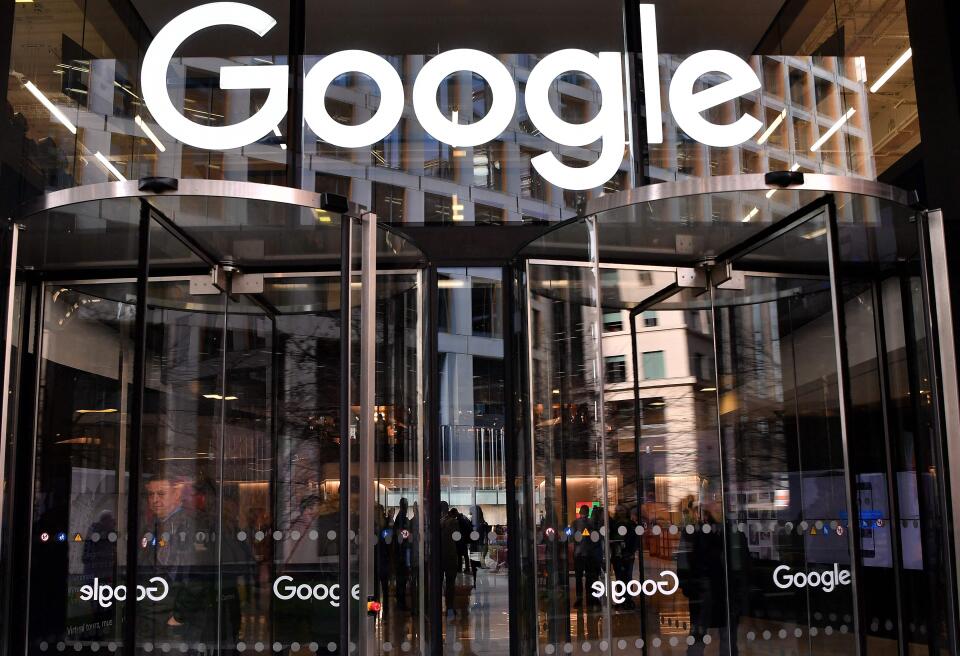 (FILES) In this file photo taken on January 18, 2019 a Google's logo is pictured above the entrance to the offices of Google in London. Google on Friday, January 14, agreed to buy a central London building complex for $1 billion, but stressed it remained committed to new hybrid working patterns in the wake of Covid. (Photo by Ben STANSALL / AFP)