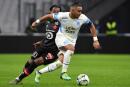 Marseille's French midfielder Dimitri Payet (R) runs with the ball next to Lille's Portuguese midfielder Renato Sanches during the French L1 football match between Olympique Marseille (OM) and Lille OSC at the Velodrome Stadium in Marseille, southern France, on January 16, 2022. (Photo by Sylvain THOMAS / AFP)