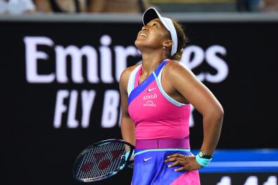 Japan's Naomi Osaka reacts as she plays against Amanda Anisimova of the US during their women's singles match on day five of the Australian Open tennis tournament in Melbourne on January 21, 2022. -- IMAGE RESTRICTED TO EDITORIAL USE - STRICTLY NO COMMERCIAL USE -- (Photo by William WEST / AFP) / -- IMAGE RESTRICTED TO EDITORIAL USE - STRICTLY NO COMMERCIAL USE --
